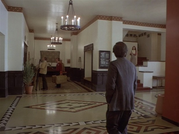The Shining - Jack approaches the office and sees the maze and woman coming down the stairs